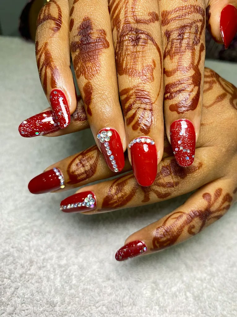Red embellished nail extensions